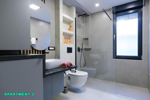 a bathroom with a toilet and a sink and a shower at Residence 14 Sarajevo in Sarajevo