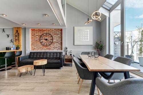 a living room with a couch and a table at Waterlane by Vivendi Properties in Gdańsk