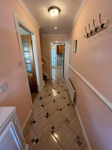 a hallway with a tiled floor in a house at Corrigs Retreat in Newcastle