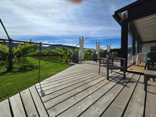 a wooden deck with a view of the ocean at Antico Fienile Agritur in Mezzocorona