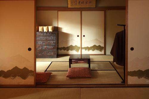 a dressing room with a mirror and a cabinet at Tsuruya Ryokan in Karuizawa
