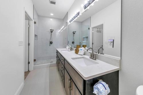 a bathroom with a sink and a large mirror at Rustic Oasis in Panama City Beach