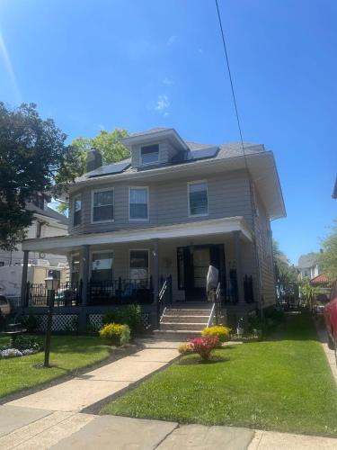 a large house with a porch and stairs to the door at Elizabeth New Jersey bedroom -Newark Airport -New York City in Elizabeth