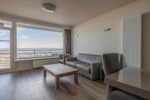 uma sala de estar com um sofá e uma grande janela em "Brussel" - Amazing Seaview Apartment in Ostend em Ostend