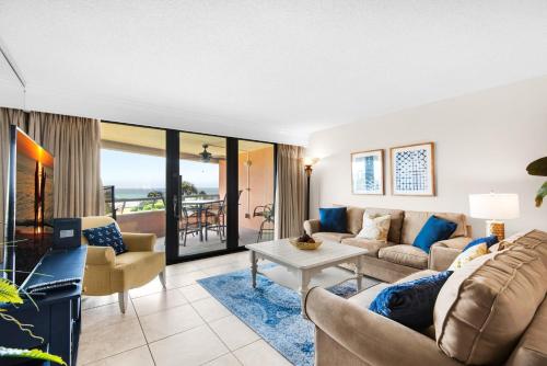 a living room with a couch and a table at Edgewater #303 in Destin