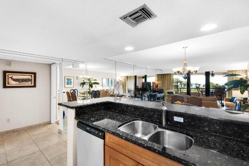 a kitchen with a sink and a living room at Edgewater #303 in Destin
