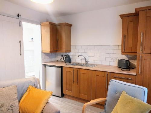 a kitchen with a sink and a counter top at Charming 1 bedroom self-contained flat. in Wellington