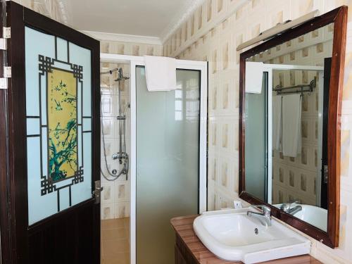 a bathroom with a sink and a mirror at HOTEL NOKRAS (K) LIMITED in Murangʼa