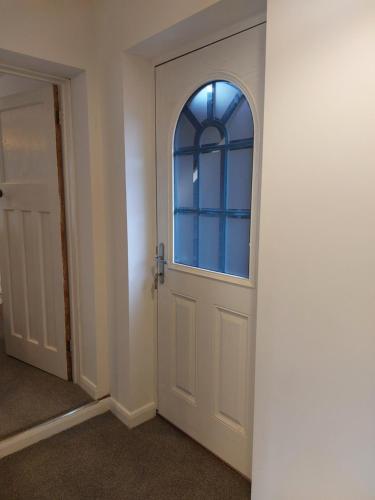 an empty room with a white door with a window at Charming 1 bedroom self-contained flat. in Wellington