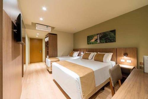een slaapkamer met een groot bed en een flatscreen-tv bij Prime Airport Hotels With Free Shuttle Service in Arnavutköy