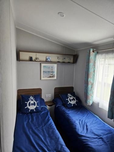 a small room with two beds in a boat at Haven Kent Coast Allhallows sleeps 8 in Allhallows