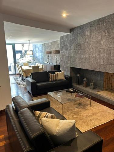 a living room with a couch and a fireplace at 2Stay - Luxury in Ponta Delgada