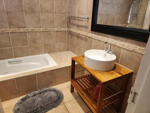 a bathroom with a sink and a bath tub at Valley Inn Guest House, Accommodation 6, Drakenstein Avenue in Sandown
