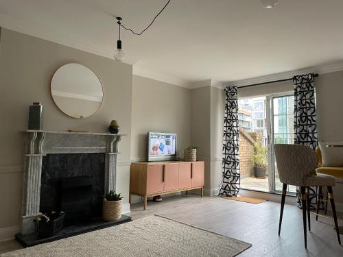 a living room with a mirror and a fireplace at Home by the Liffey in Dublin