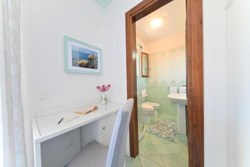 a bathroom with a sink and a toilet at Villa Eleonora, un angolo di Paradiso ad Ischia in Ischia