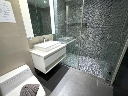 a bathroom with a sink and a shower at Sea view studio with private terrace & pool in Patong Beach