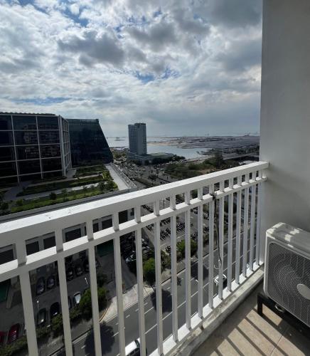 a balcony with a view of a city at 1br Shore Residences Staycation at Royels Place in Manila
