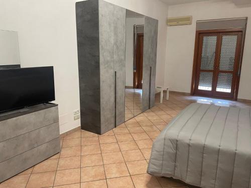 a living room with a bed and a television at A Casa di Luca in Campagna