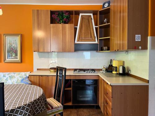 a kitchen with wooden cabinets and a stove top oven at CASA MIMOSA check-in on line in Domaso