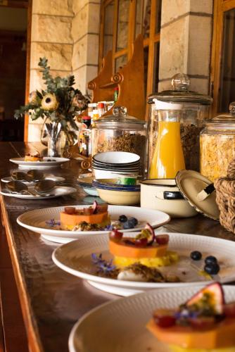 a buffet with plates of food on a counter at Moolmanshoek Private Game Reserve in Fouriesburg