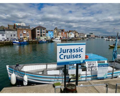 a sign that reads jurassic cruises on a boat in a harbor at Penn House Hotel in Weymouth