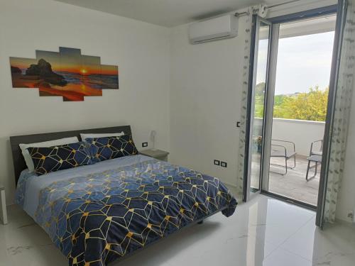 a bedroom with a bed and a balcony at OrizzonteMare in Ortona