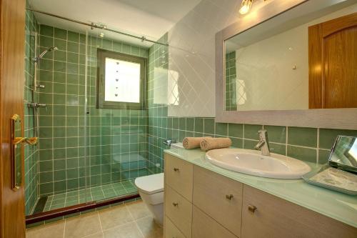 a bathroom with a sink and a toilet and a mirror at Montgrí 27 in Palafrugell