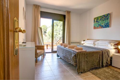 a bedroom with a bed and a sliding glass door at Montgrí 27 in Palafrugell