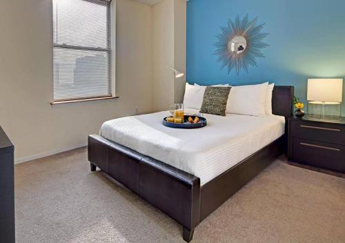a bedroom with a bed with a tray of fruit on it at Beautiful Studio Apartment in NYC! in New York