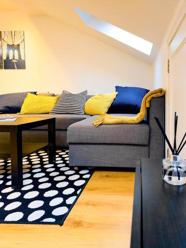a living room with a couch and a table at Charming London Home, Opp Arnos Grove Underground Station, Parking in New Southgate
