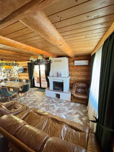 a living room with a couch and a fireplace at Molfar Resort Hotel & SPA Карпати in Shaian