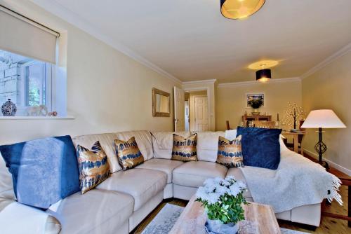 a living room with a white couch and blue pillows at Ingledale Apartment, Ingleton, Yorkshire Dales National Park, Near The Lake District Pet Friendly in Ingleton 