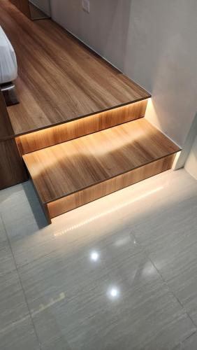 a set of wooden stairs with a light on them at Kakurega Manila in Manila