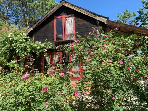 an old house with flowers in front of it at Romantic house 2 on a pine hill Dalat in Da Lat