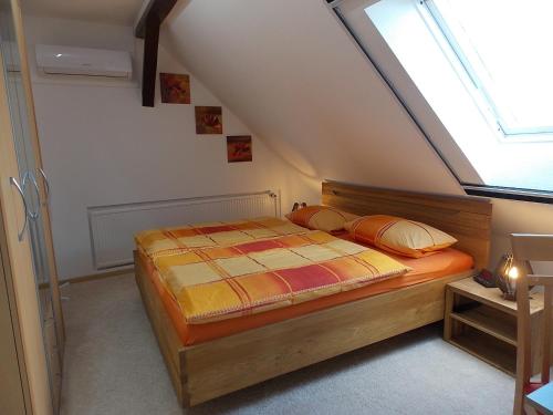 a bedroom with a bed in a attic at Ferienwohnung Mohnblume - a44686 in Gerswalde