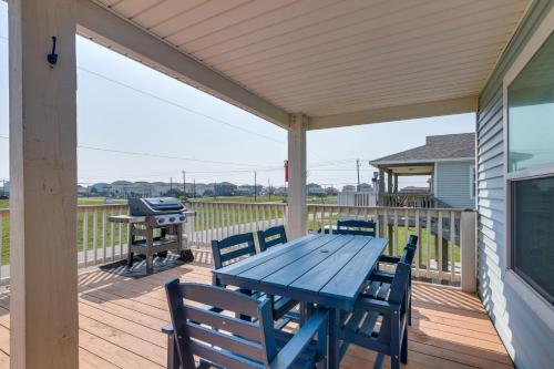 a blue table and chairs on a deck with a grill at Walk to Shore Surfside Beach Home with Bay Views in Surfside Beach