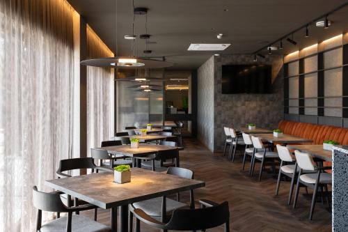 a row of tables and chairs in a restaurant at Molėtai Hotel in Molėtai