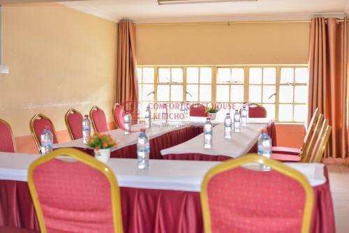 a set of tables and chairs in a room at Heritage Villa Hotel & Accomodation in Kericho