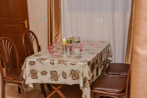 a dining room table with a white table cloth at Heritage Villa Hotel & Accomodation in Kericho