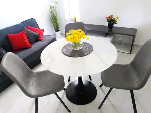 a white table and chairs in a living room at Vale in Pirovac