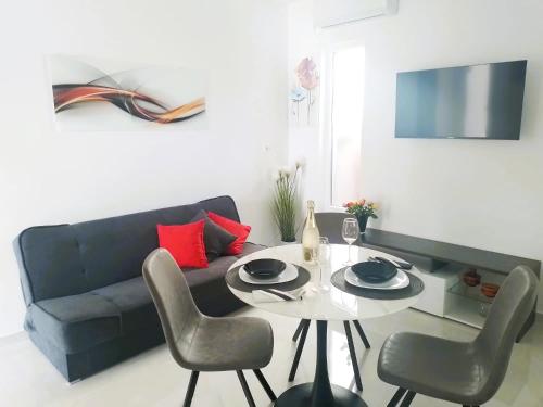 a living room with a table and a couch at Vale in Pirovac