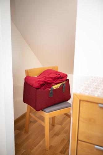 a red suitcase sitting on a chair in a room at Ferienhaus Nuova Via in Griffen