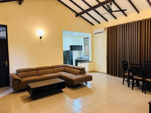 a living room with a couch and a table at Viveka Serviced Apartments in Nugegoda