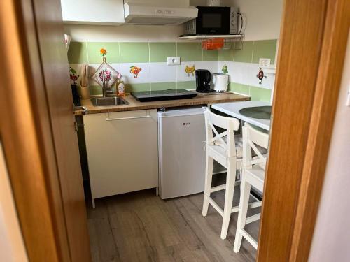 a small kitchen with a sink and a counter at Sončni zahod in Kobarid