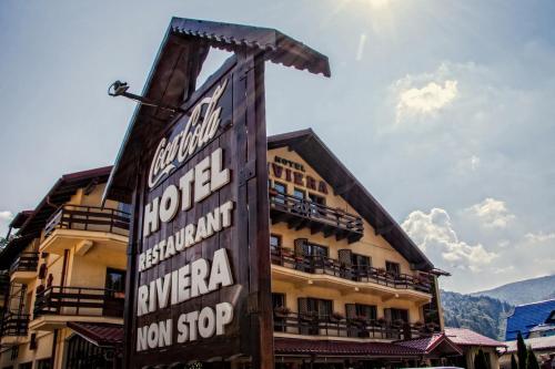 a sign for a hotel in front of a building at Hotel Riviera in Sinaia