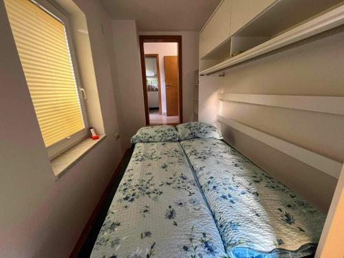 a bedroom with two beds and a window at Sončni zahod in Kobarid