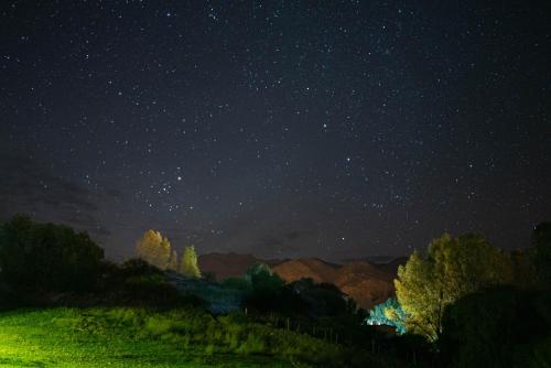 a starry night with the milky way at Loma Puskana - Hostería in Cachí