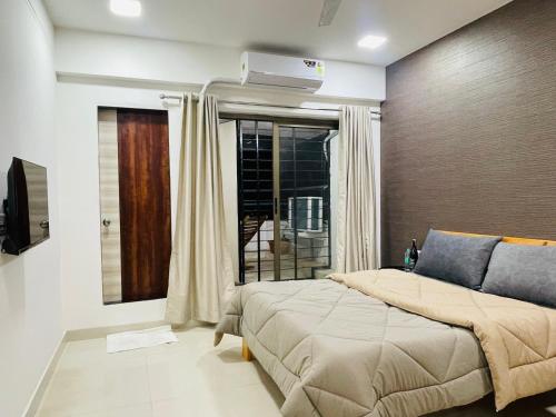 ein Schlafzimmer mit einem großen Bett und einem Fenster in der Unterkunft STAYLUXE-MUMBAI AIRPORT in Mumbai