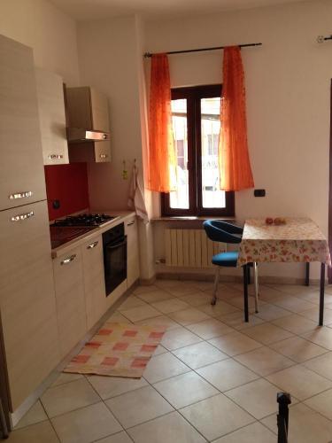 a kitchen with a table and a table and a window at BeB Orio in Capriate San Gervasio