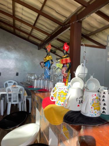 a kitchen counter with a bunch of dishes on it at Hospedaje MorroSP in Morro de São Paulo
